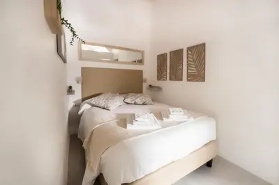 a bedroom with a bed in a white room at White Ostilia Apartments in Rome