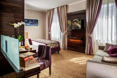 a hotel room with a bed and a living room at Gioberti Art Hotel in Rome