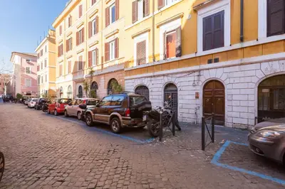 a row of cars parked in front of a building at Trastevere Suite Just Renewed in Rome