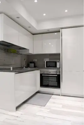 a kitchen with white cabinets and a microwave at Castelfidardo Apartment in Rome