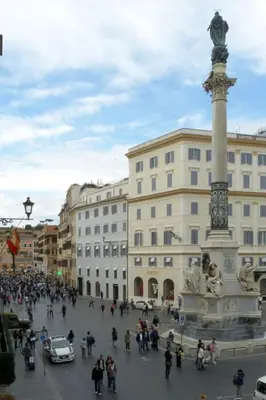 a crowd of people standing around a monument in a square at Apartment Appartement mit Dachterrasse by Interhome in Rome