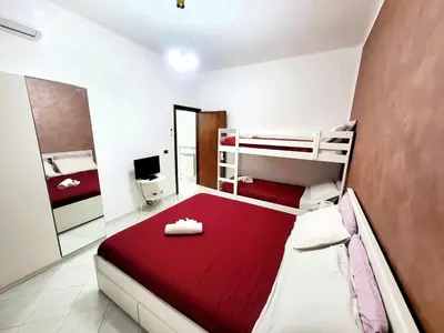 a bedroom with two bunk beds and a red blanket at Apartment 'Rhome Sweet Rhome by Interhome in Rome