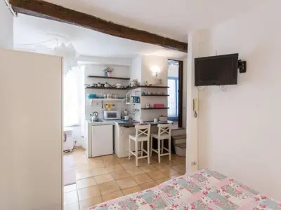 a room with a kitchen with a table and a counter at Apartment in Trastevere im Herzen von Rom by Interhome in Rome
