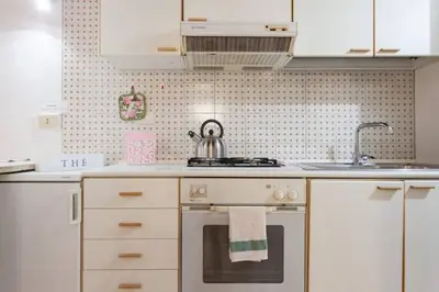 a kitchen with a stove with a tea kettle on it at House&Colosseum in Rome