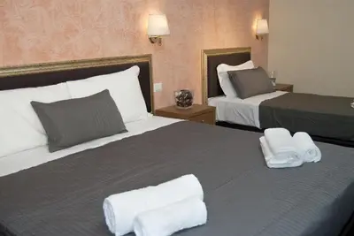 a hotel room with two beds with white towels on them at Guest's Heaven in Rome