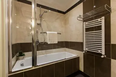 a bathroom with a bath tub and a shower at Guest's Heaven in Rome