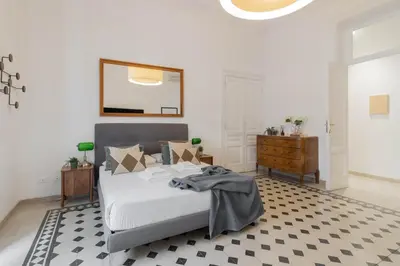 a bedroom with a bed with a mirror and a dresser at Luxury Spagna Apartments in Rome