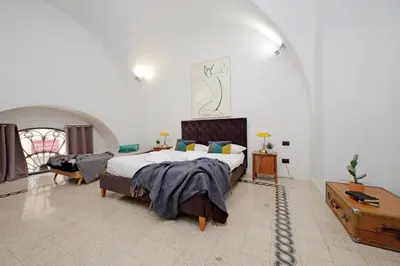 a bedroom with a large bed in a white room at Luxury Spagna Apartments in Rome