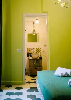 a bathroom with a sink and a bed in a room at Terrazza Munira Trastevere in Rome