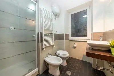 a bathroom with a toilet and a sink and a shower at Rome To You- The Place to be&B in Rome