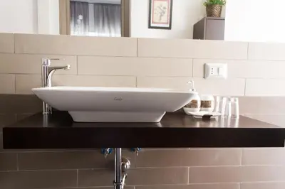 a white sink on a black counter in a bathroom at Rome To You- The Place to be&B in Rome