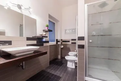 a bathroom with two toilets and a sink and a shower at Rome To You- The Place to be&B in Rome