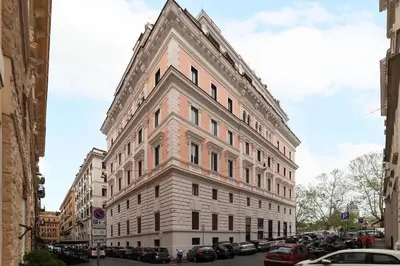 a large building on a city street with parked cars at Loft tra Castel Sant'Angelo e centro storico in Rome