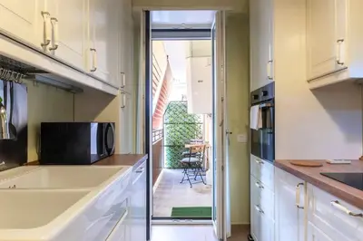 a kitchen with a sink and a microwave at Nuovo e ampio appartamento vicino metropolitana in Rome