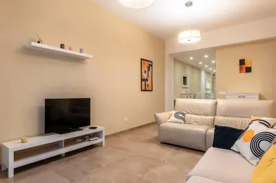 a living room with a couch and a flat screen tv at Nuovo e ampio appartamento vicino metropolitana in Rome