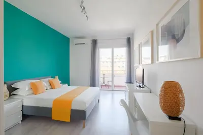 a bedroom with a bed and a blue wall at Appartamento panoramico vicino San Pietro e Vaticano in Rome
