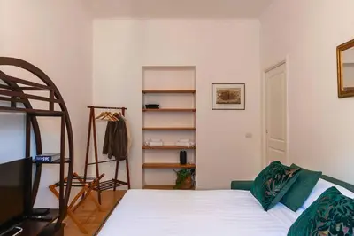 a bedroom with a bed and a book shelf at Appartamento nel cuore del pittoresco Pigneto in Rome
