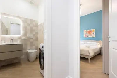 a bathroom with a sink and a bed in a room at Nuovo appartamento ben collegato con il centro in Rome