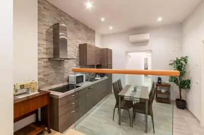 a kitchen with a table and a dining room at 3 comodi posti letto vicino Castel Sant'Angelo in Rome