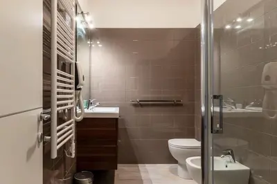 a bathroom with a toilet and a sink at 3 comodi posti letto vicino Castel Sant'Angelo in Rome