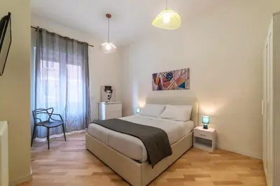 a bedroom with a bed and a chair in it at Appartamento moderno a 5 minuti dal Vaticano in Rome