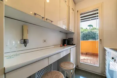 a kitchen with a counter with two chairs and a window at Delizioso loft con terrazzo panoramico a Flaminio in Rome