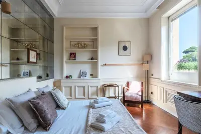 a living room with a bed and a window at Delizioso loft con terrazzo panoramico a Flaminio in Rome