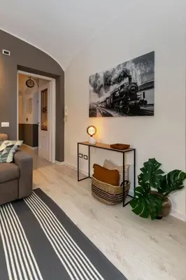 a living room with a couch and a train painting on the wall at Stazione Termini - primo piano con ascensore in Rome