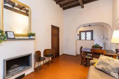 a living room with a table and a mirror at Autentico appartamento vicino al Pantheon in Rome