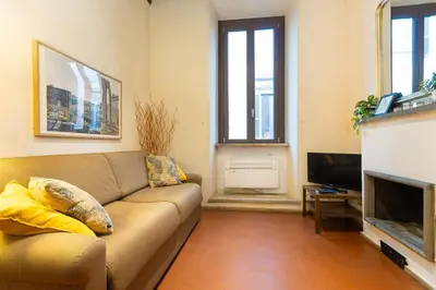 a living room with a couch and a television at Autentico appartamento vicino al Pantheon in Rome