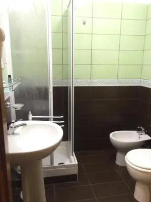 a bathroom with a sink and a toilet and a shower at Appartamenti Romatour in Rome
