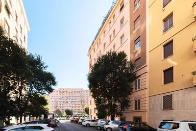 a city street with cars parked next to buildings at Elegante appartamento vicino il Vaticano in Rome