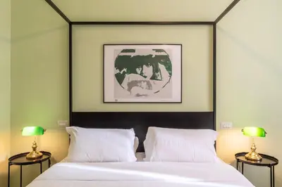 a bedroom with two beds and two lamps at Elegante appartamento vicino il Vaticano in Rome