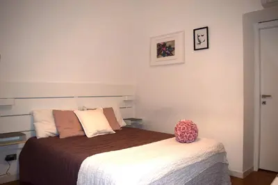 a bedroom with a bed with a brown and white blanket at Apartment Termini in Rome