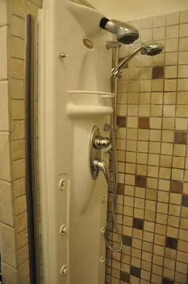 a shower in a bathroom with a shower head at Rome Imperial Crown in Rome