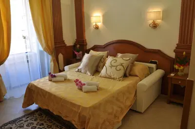 a bedroom with a bed with two stuffed animals on it at Rome Imperial Crown in Rome
