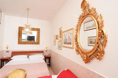 a bedroom with two beds and a mirror at Terrazza San Pietro in Rome