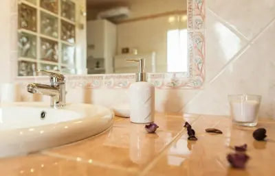a bathroom with a sink and a mirror and flowers at Terrazza San Pietro in Rome