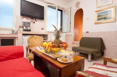 a living room with a table with a bowl of fruit at Terrazza San Pietro in Rome
