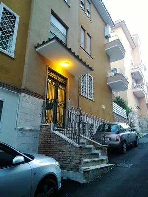 a car parked in front of a building with a door at Il Cavaliere in Rome