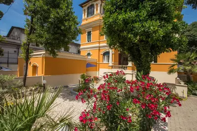 a yellow building with pink flowers in front of it at Relais La Torretta in Rome