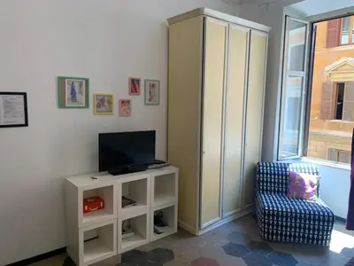 a living room with a tv and a chair at Trasteverome45 in Rome