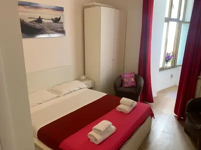 a bedroom with a bed with two towels on it at Trasteverome45 in Rome