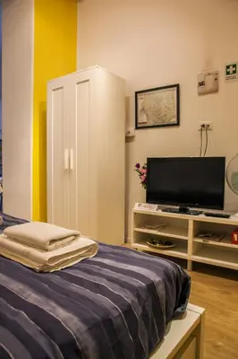 a bedroom with a bed and a flat screen tv at Trasteverome45 in Rome