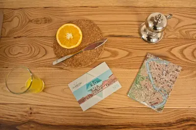 a table with an orange slice and a glass of orange juice at Glamroom Luxury Terrace in Rome
