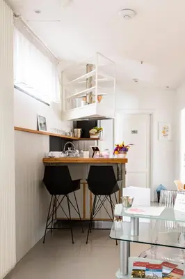 a small kitchen with a counter and stools at Glamroom Luxury Terrace in Rome