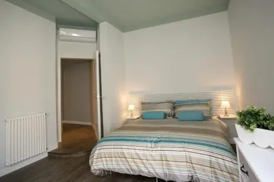 a bedroom with a large bed with blue pillows at Cola Di Rienzo A E B in Rome