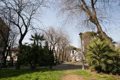 a park with palm trees and a street light at Cola Di Rienzo A E B in Rome