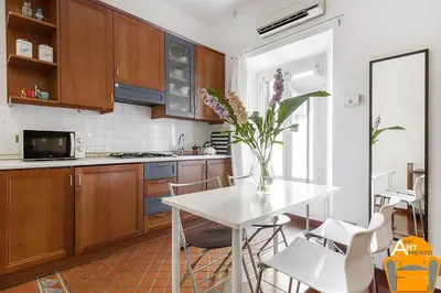 a kitchen with a table with a vase of flowers on it at 4BNB - Vatican Doors Flat in Rome