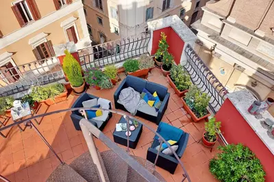 an overhead view of a balcony with chairs and plants at Spagna Penthouse in Rome